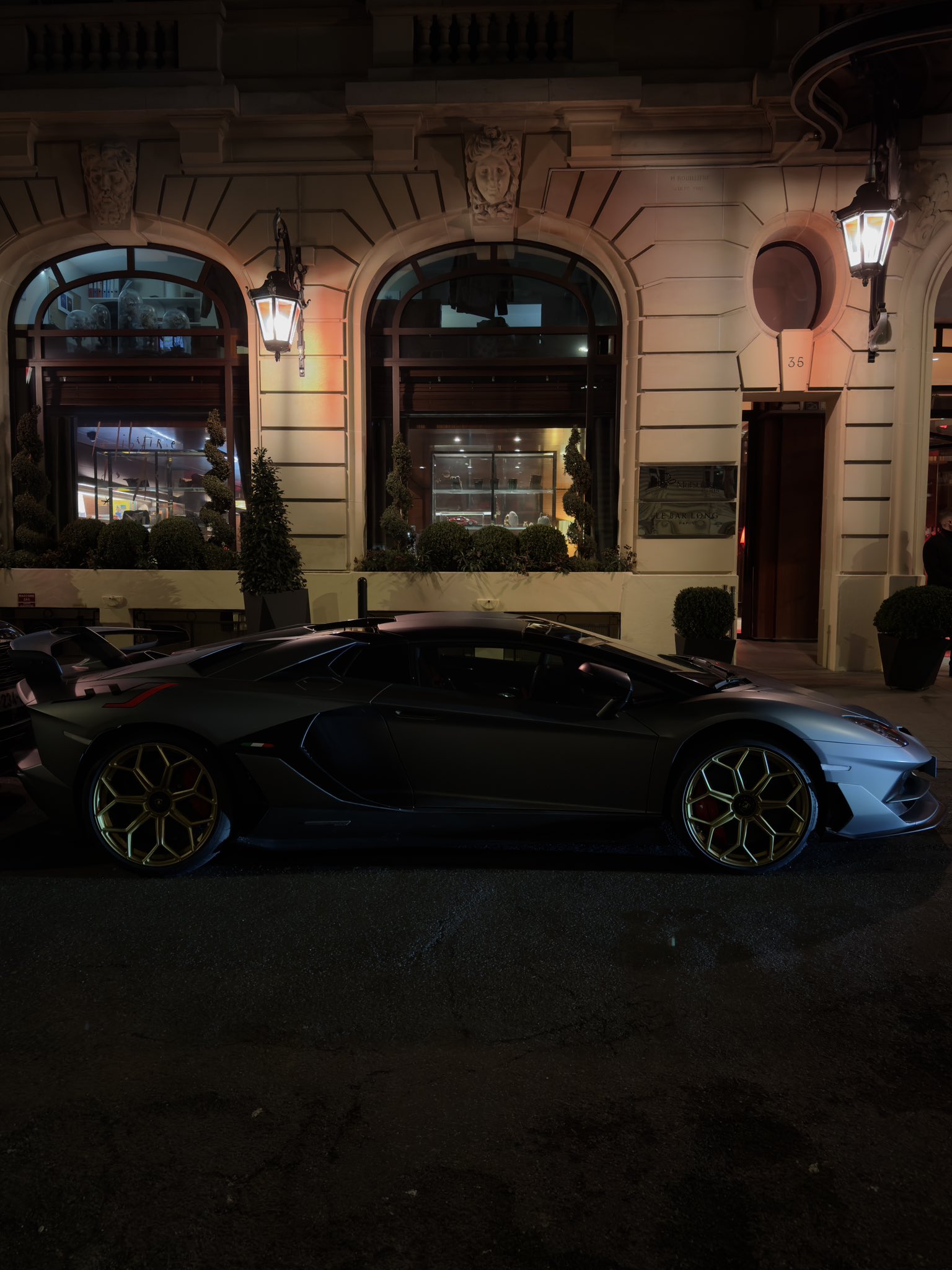A car outside a city restaurant at night