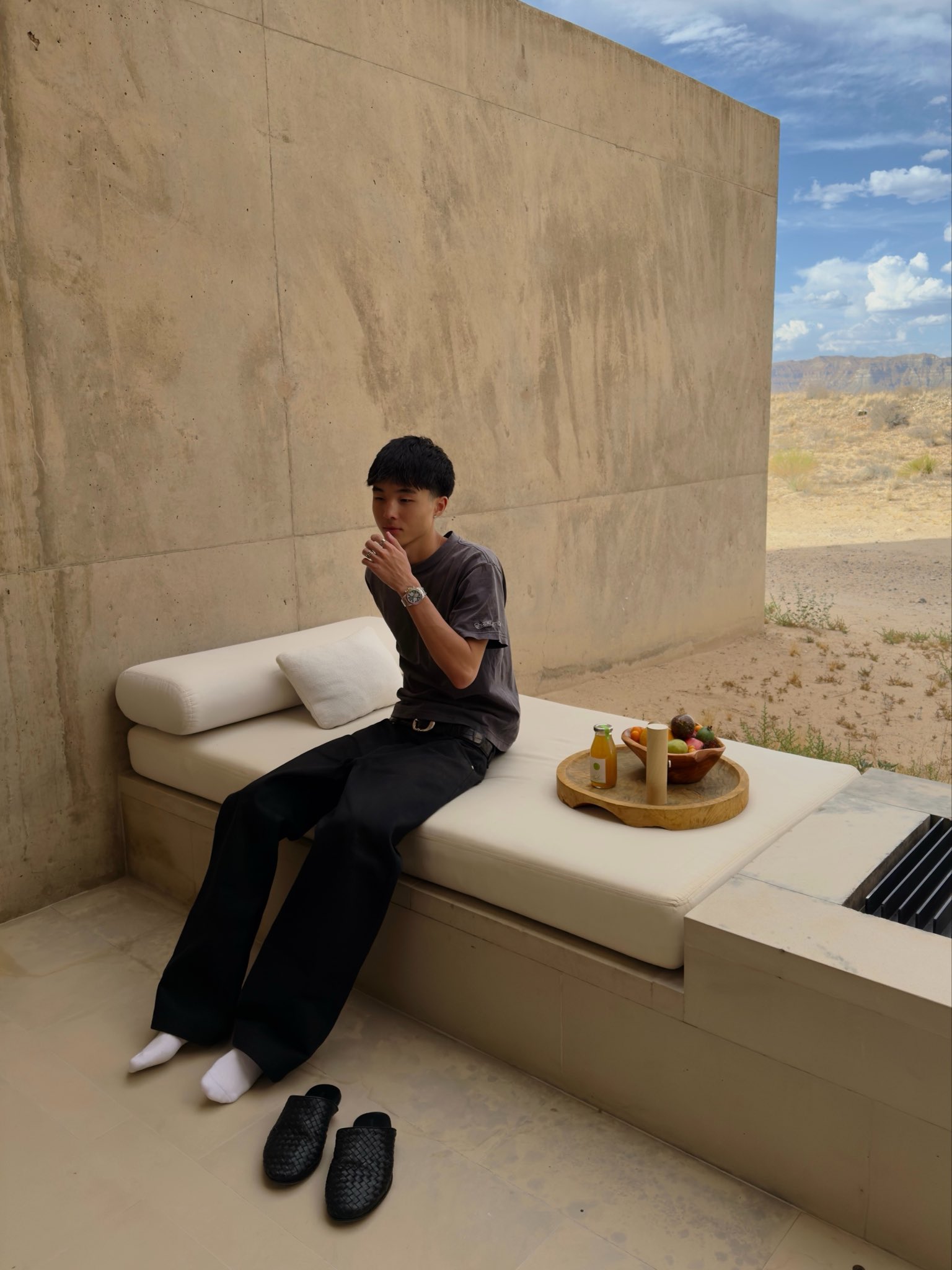 Clayton Kim in a modern stone courtyard